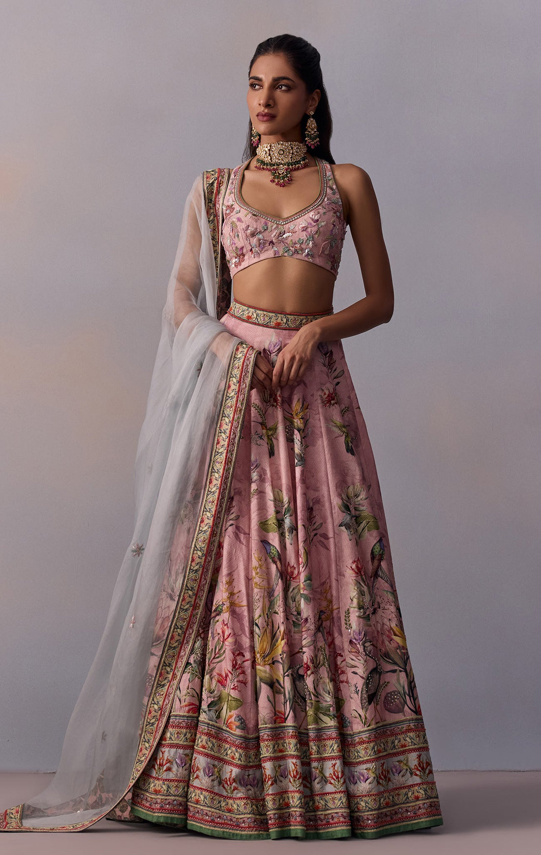 Hand-painted and printed floral motif design in two delicate pastel tones Comes with a stylish organza dupatta that frames the blouse back beautifully Perfect outfit for day-to-evening wedding festivities