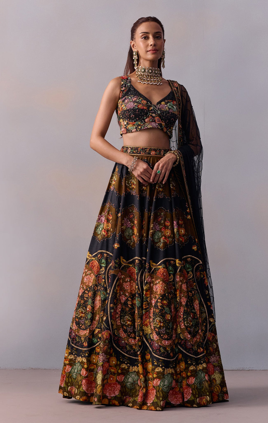 Naaz Lehenga Set — Viscose silk and tulle with vintage floral and paisley motifs, paired with a V-neckline blouse carrying heavy hand embroidery. A designer black wedding lehenga that earns the description honestly. Every detail is deliberate, nothing is decorative for its own sake. For the woman who dresses with complete conviction.