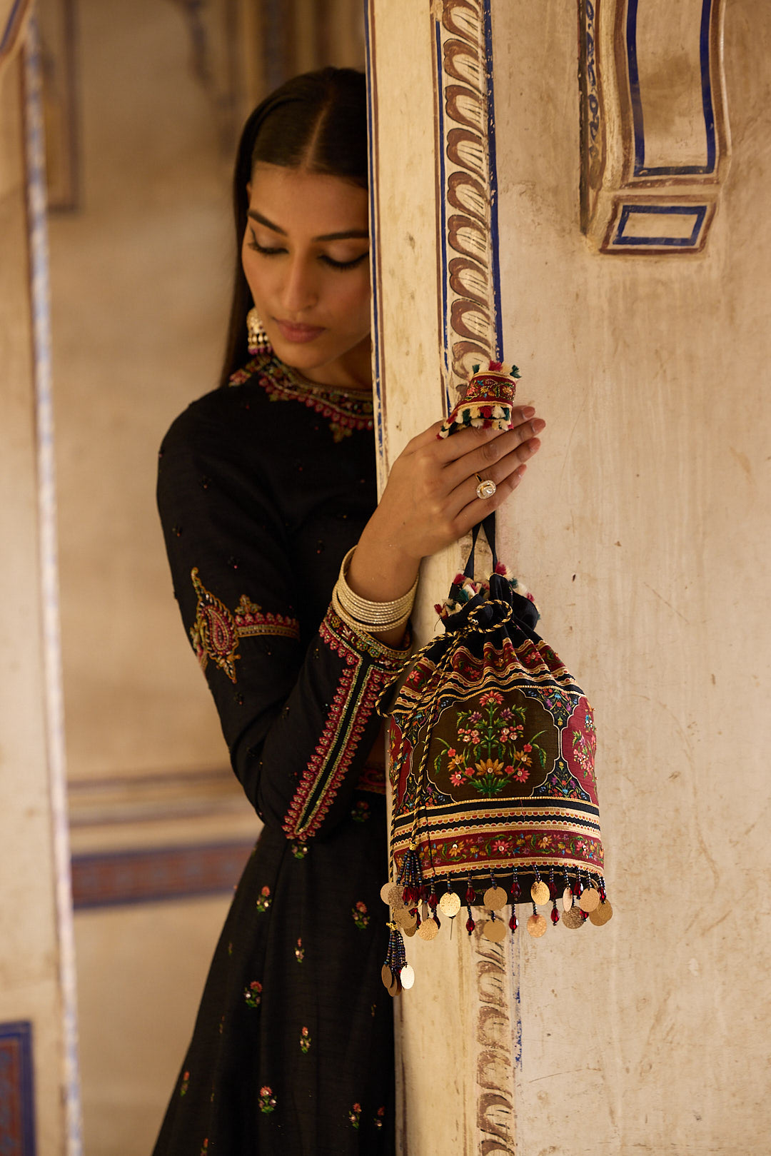 Why it's trending: potlis sit closer to the body and don't swing while dancing, unlike a longer sling clutch. Match the potli's embroidery tone to your dupatta, not the base colour